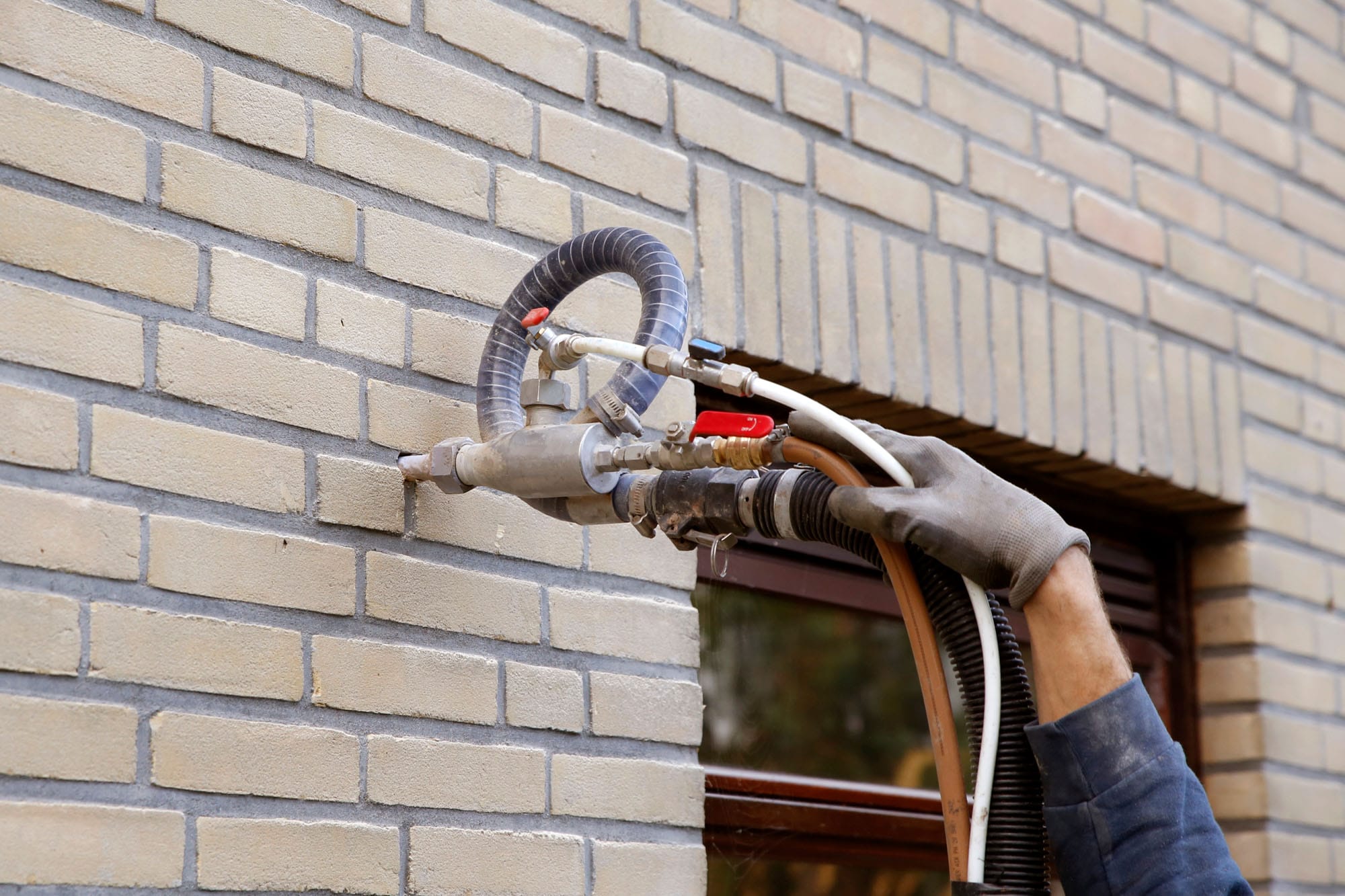 Injecting insulation into brick wall