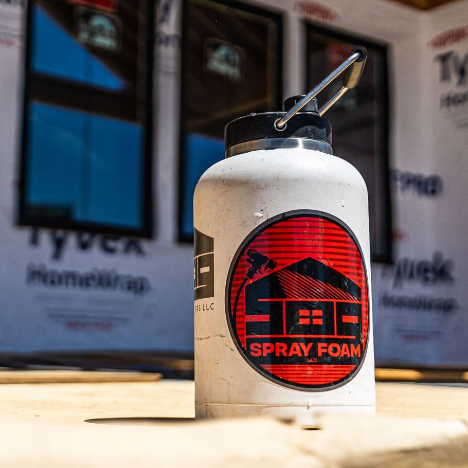 509_Spray_Foam_078 Insulated bottle with construction logo on construction site.