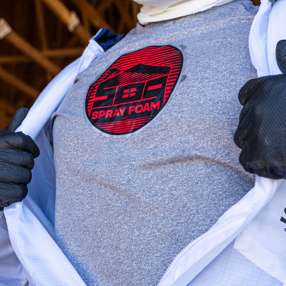 509_Spray_Foam_insulation_038 Person revealing spray foam logo on shirt.