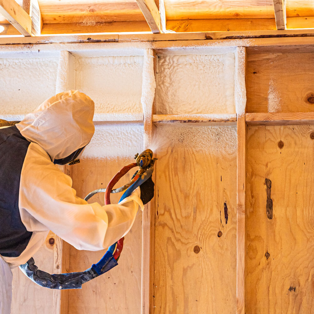 509_Spray_Foam_insulation_047 Worker applying spray foam insulation on wall.