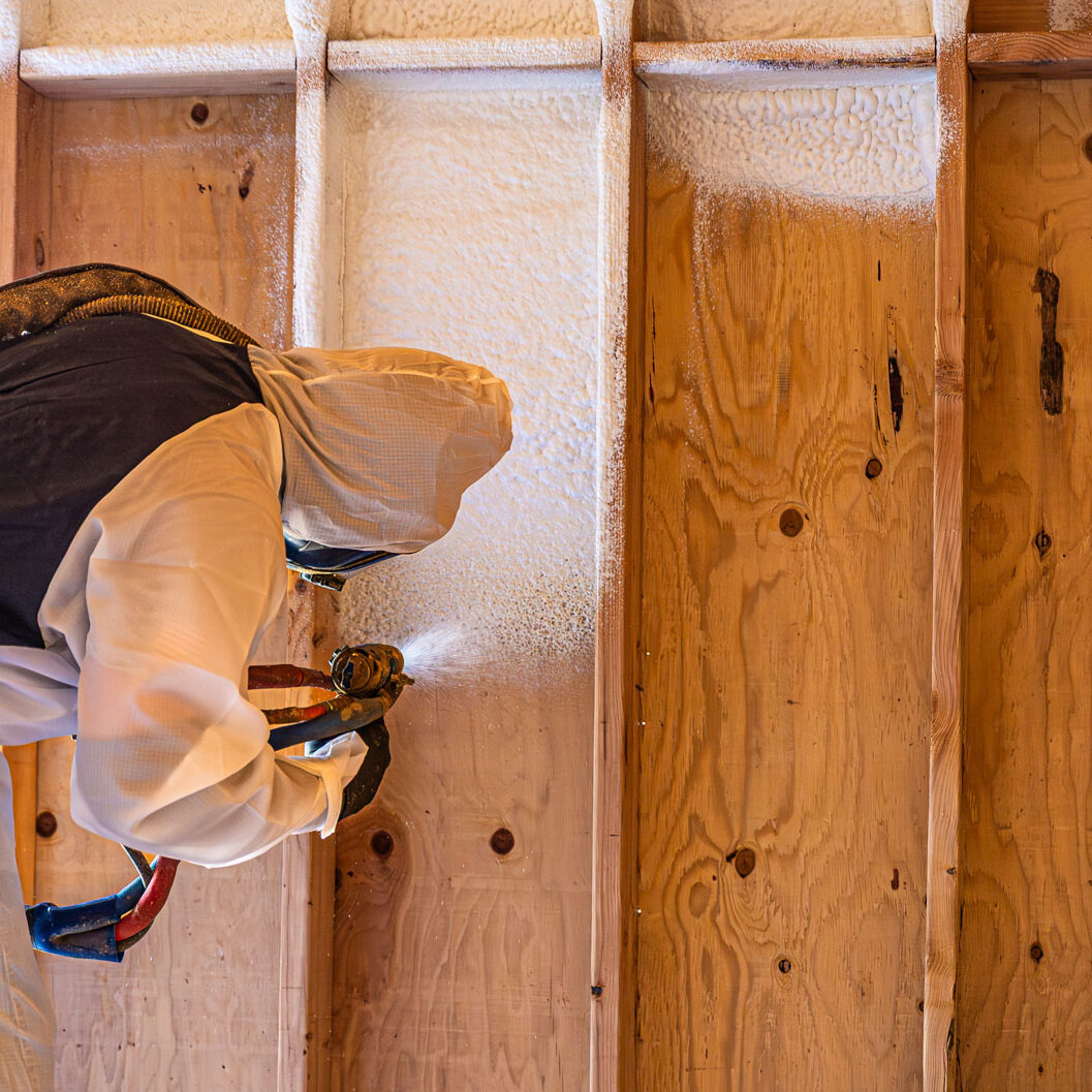 509_Spray_Foam_insulation_048 Worker spraying foam insulation on wooden wall