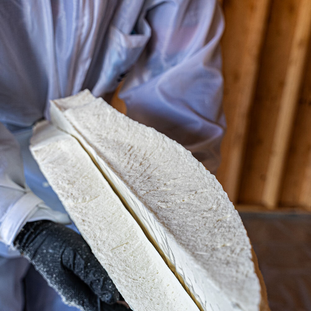 509_Spray_Foam_insulation_093 Worker handling insulation foam in construction site.