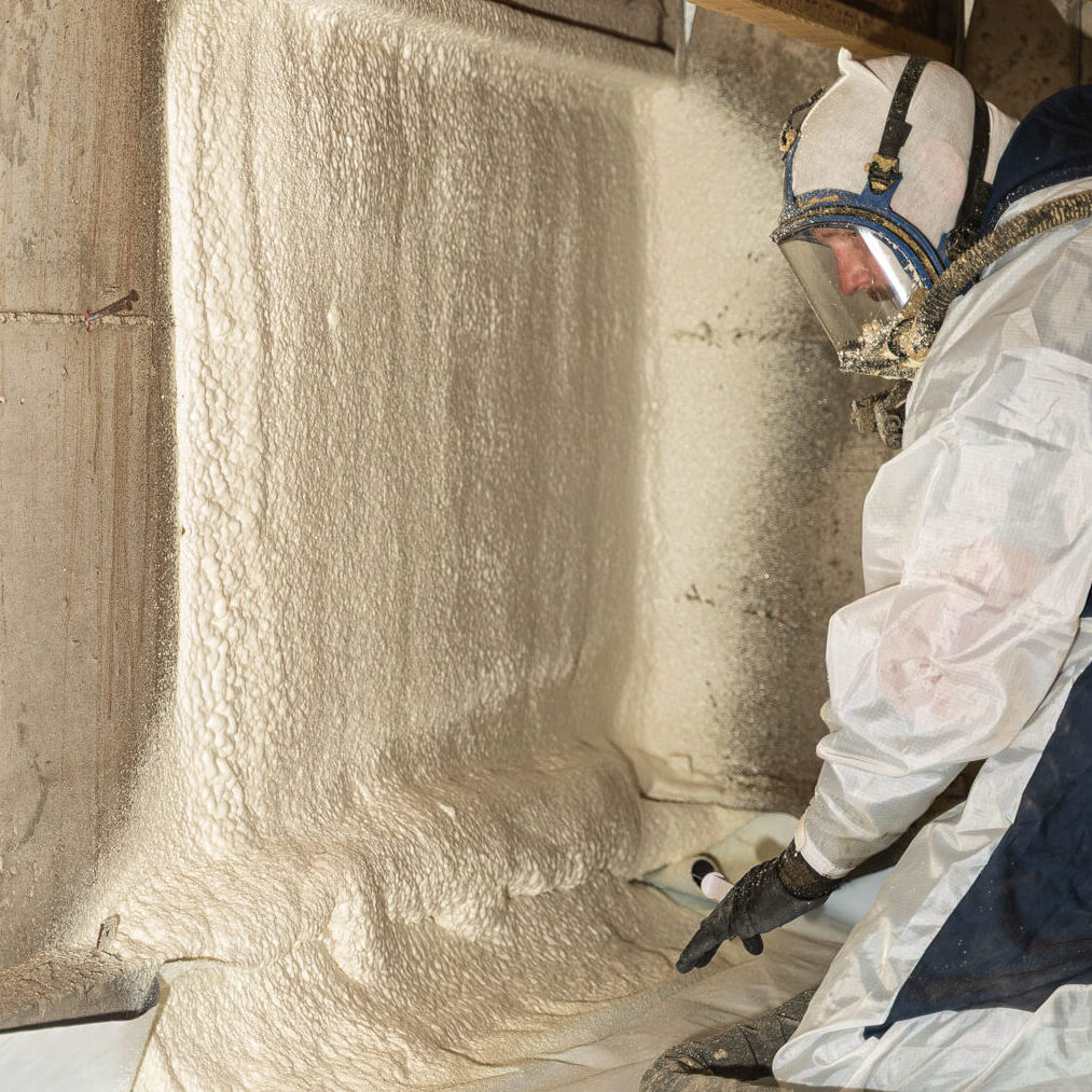 509_Spray_Foam_insulation_096 Worker applying spray foam insulation on wall.